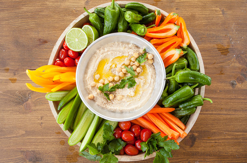 Homemade hummus with fresh vegetables image